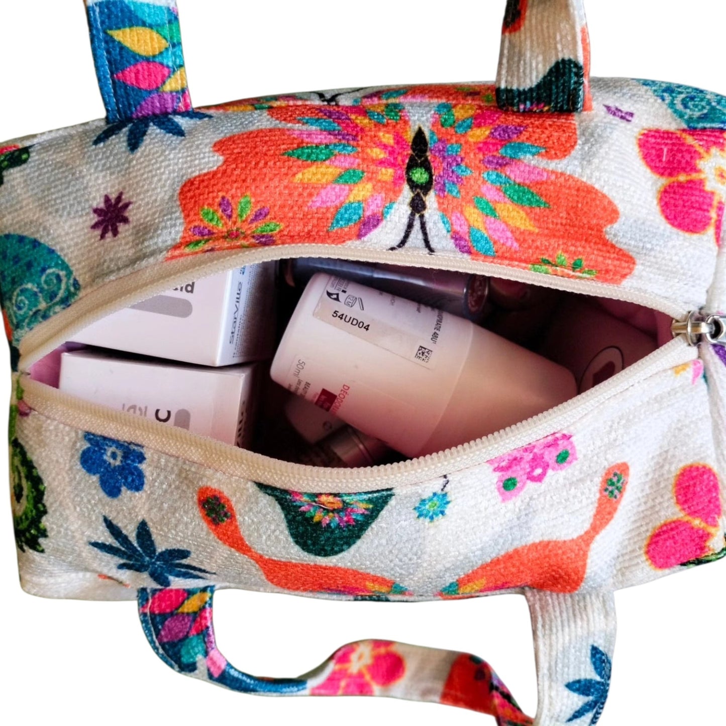 Suepatchwork handmade butterfly print fabric makeup bag with top handle and zip closure filled with beauty products