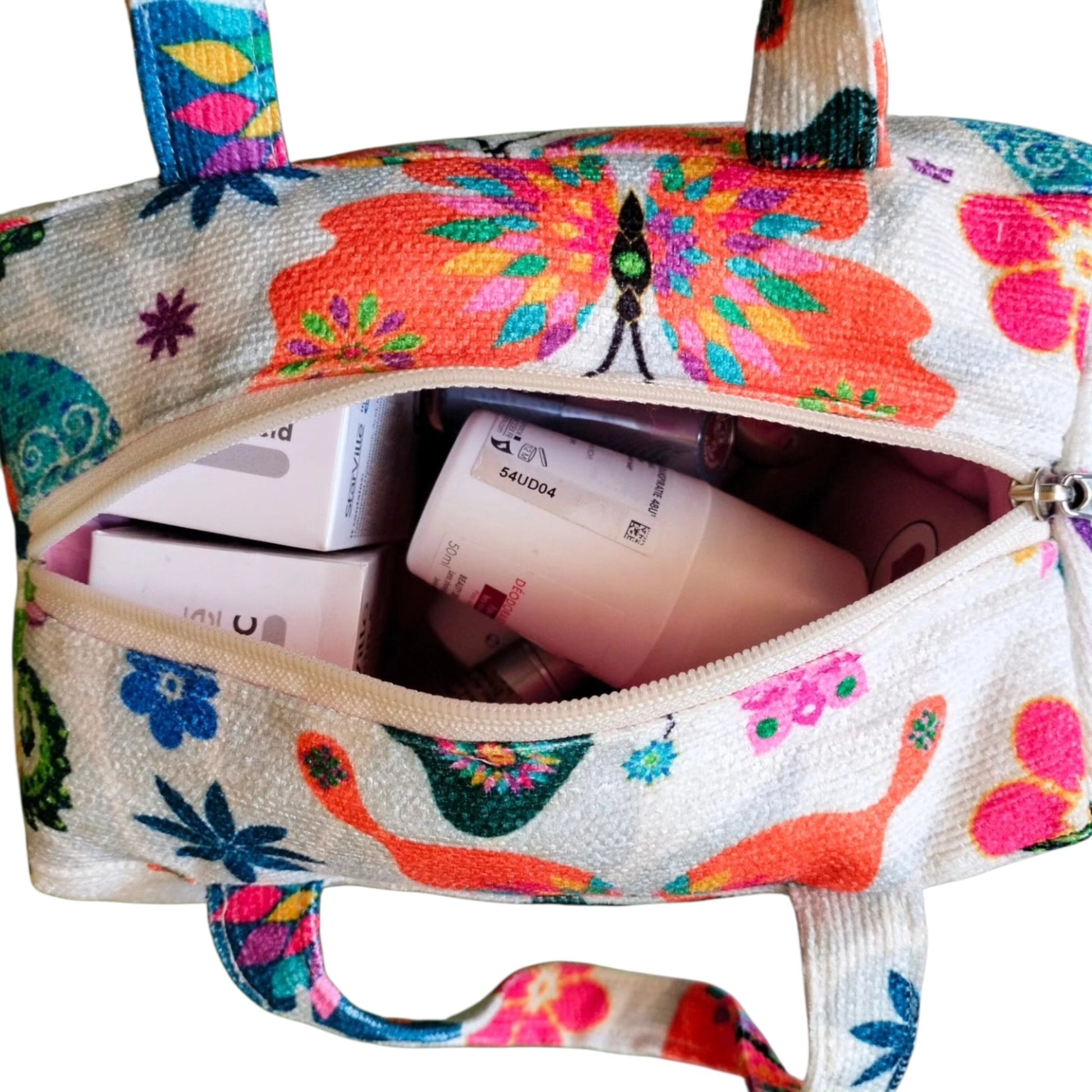 Suepatchwork handmade butterfly print fabric makeup bag with top handle and zip closure filled with beauty products