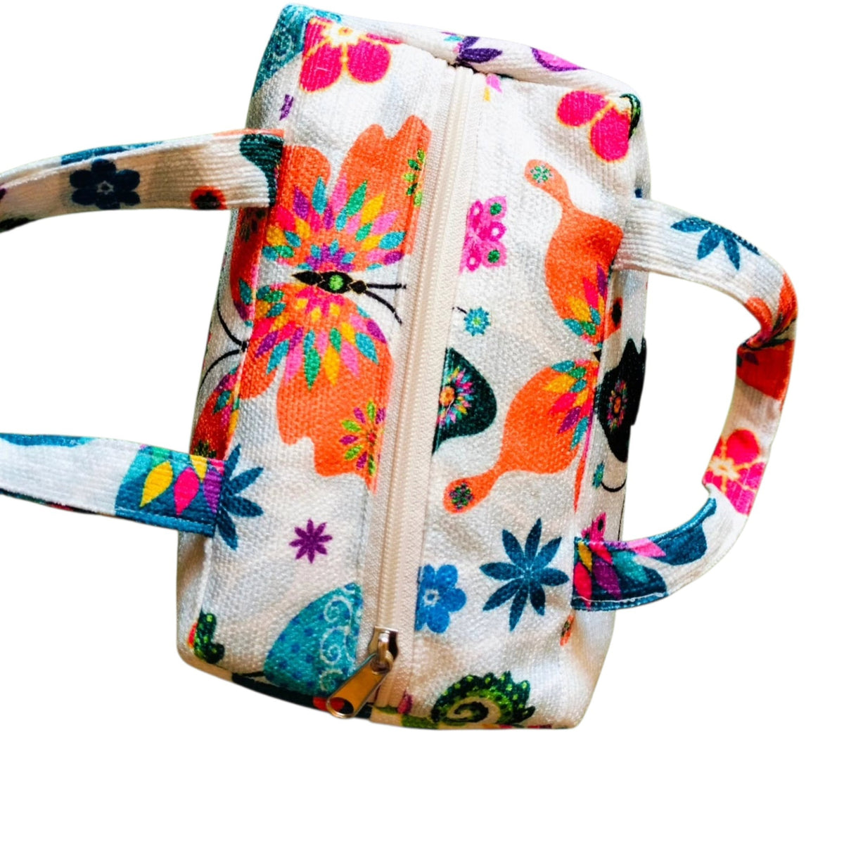 Suepatchwork handmade makeup bag with butterfly print, featuring a zip closure and carry handles in white fabric.