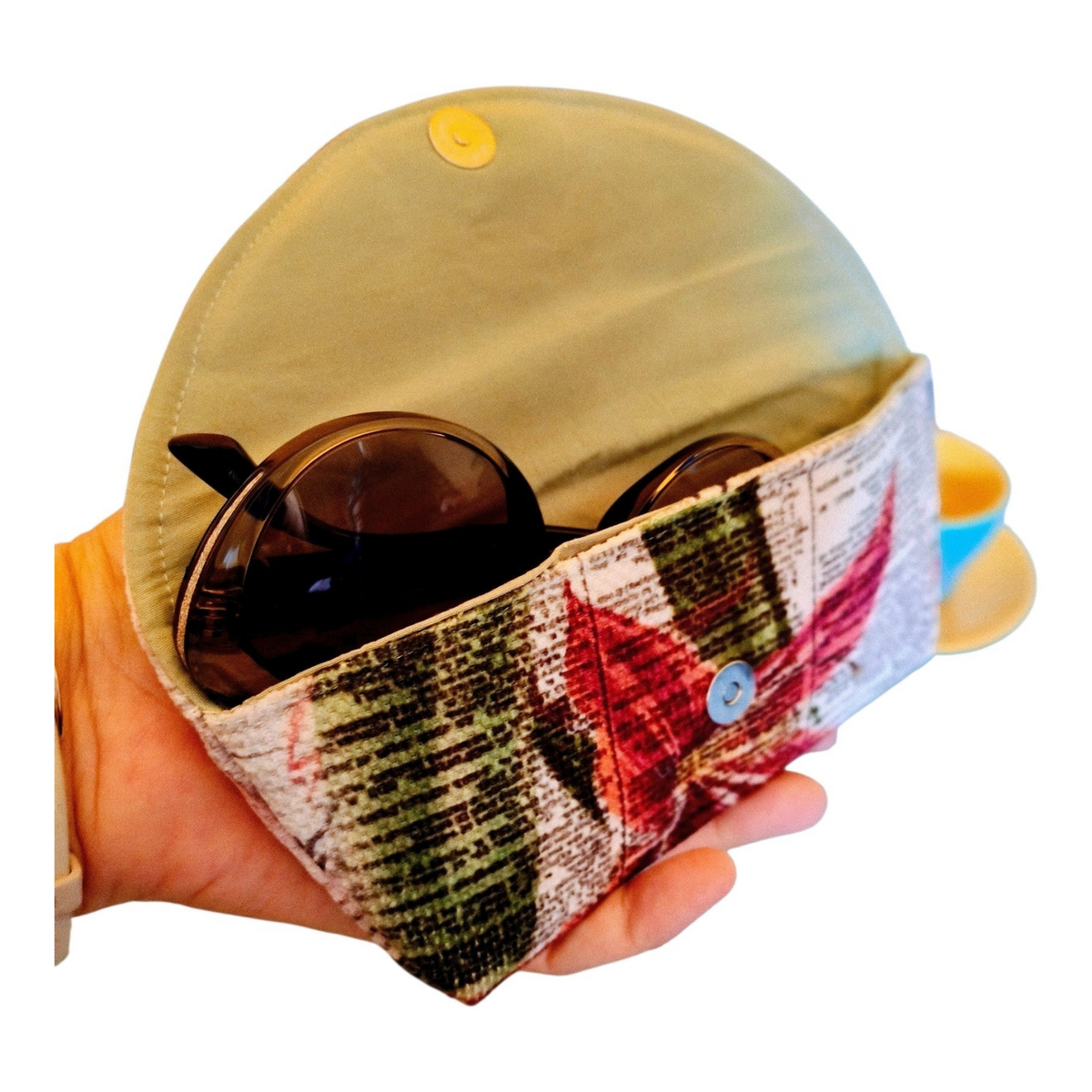 Suepatchwork handmade fabric glasses case featuring a festive Christmas flower print and a secure snap button closure.