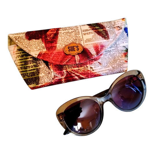 Suepatchwork handmade fabric glasses case with a festive Christmas flower and newspaper print design