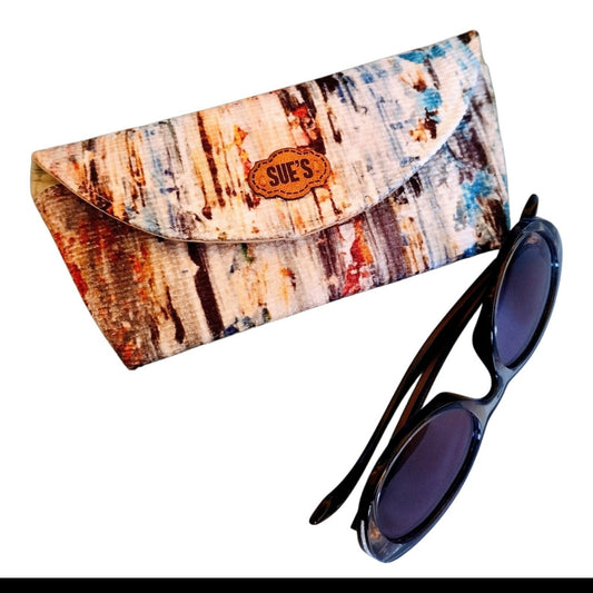 Suepatchwork handmade fabric glasses case with a colorful abstract pattern and a branded leather label