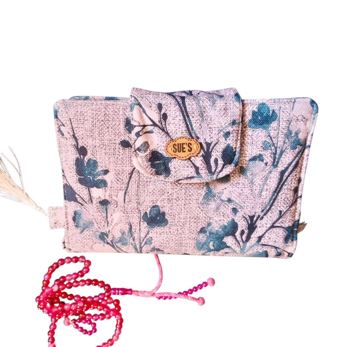 Suepatchwork handmade fabric Mus7af cover in floral print with a wooden brand tag and matching pink prayer beads