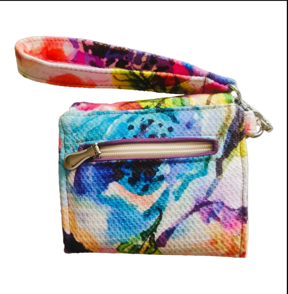 Suepatchwork fabric wristlet wallet featuring a vibrant multi-coloured abstract floral print and detachable strap
