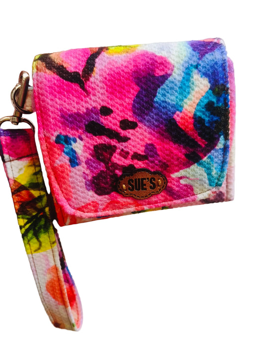 Suepatchwork fabric wristlet wallet featuring a vibrant multi-coloured abstract floral print and a detachable strap.