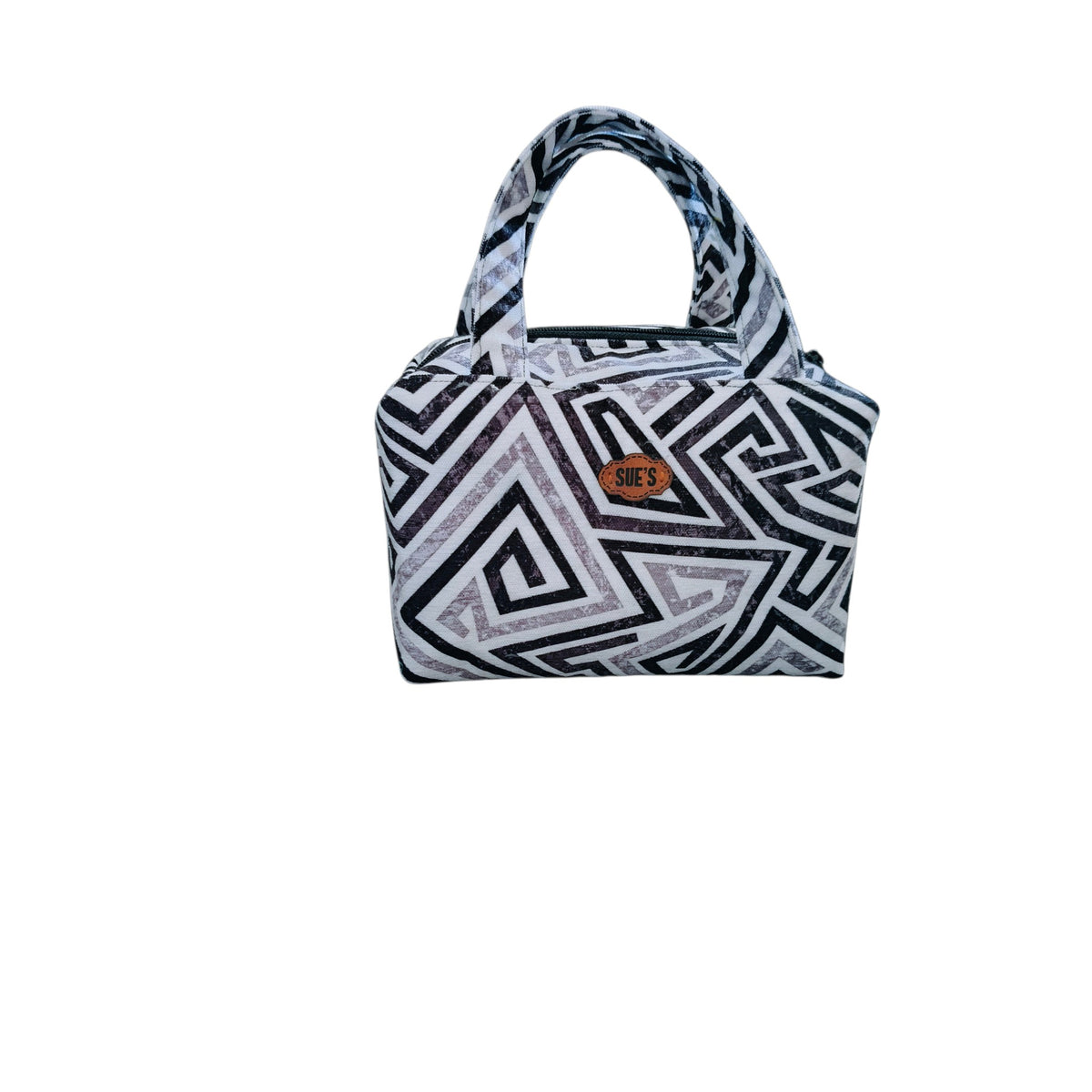 Suepatchwork handcrafted makeup bag with a black and white geometric pattern, zip closure, and a sturdy top handle.