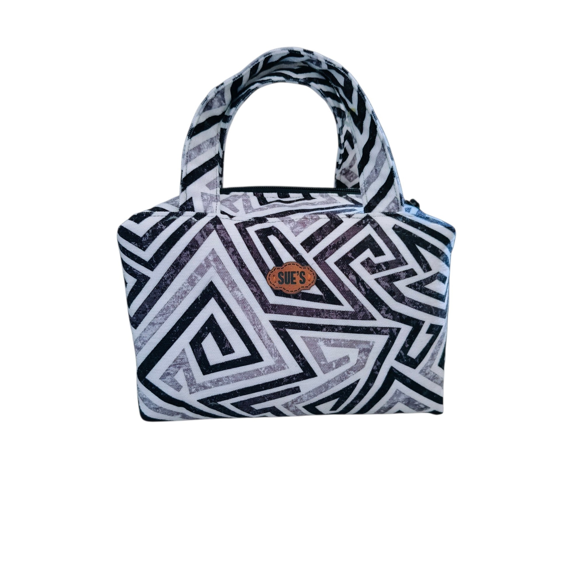 Suepatchwork handmade fabric makeup bag with a black and white geometric pattern and a convenient top handle.