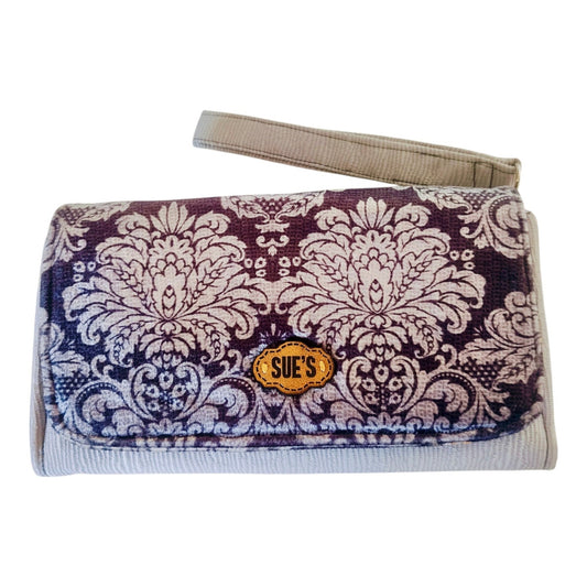 Suepatchwork gray damask print large wallet with wrist strap and branded leather tag on a marble surface