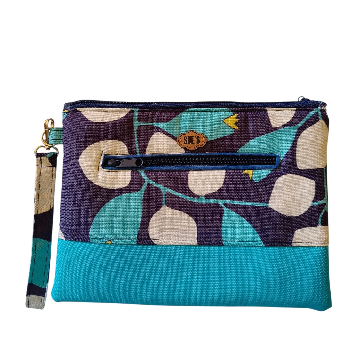 Suepatchwork handmade fabric clutch in teal and navy floral print with a wrist strap and exterior zip pocket