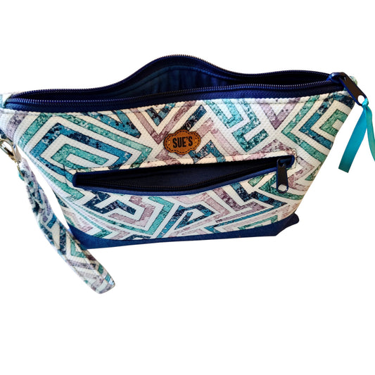 Suepatchwork Lamsa handmade clutch in blue and white geometric print fabric with a front zip pocket and wrist strap.