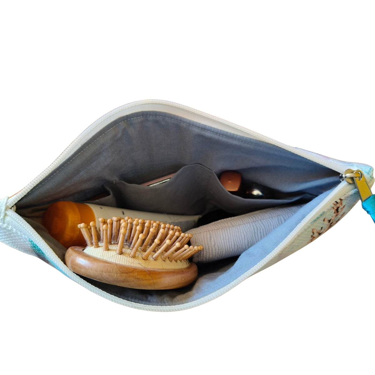 Suepatchwork Nesma 2 handmade clutch bag showing interior cotton lining, divided pockets, and organized accessories.