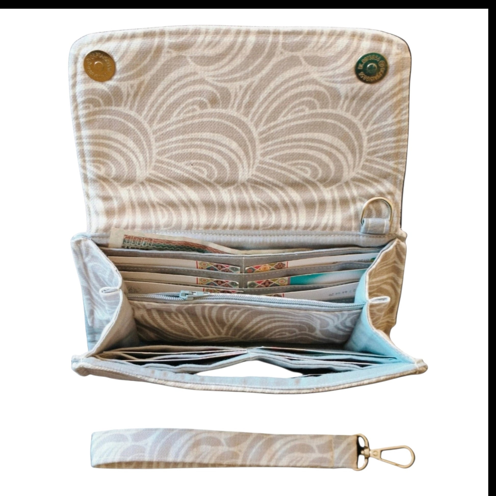 Suepatchwork off-white patterned fabric wallet with multiple card slots, zip pocket, and detachable wrist strap.