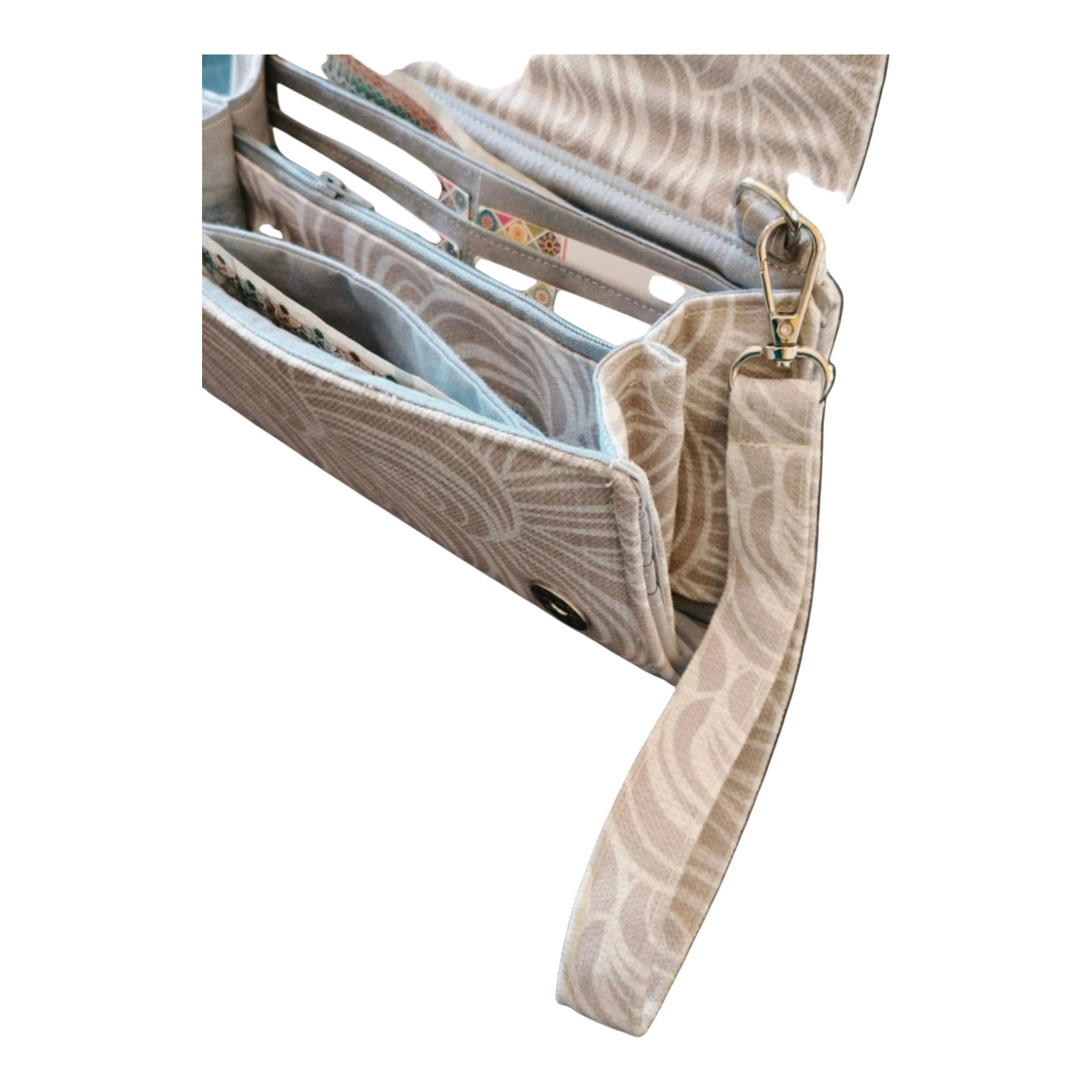 Suepatchwork off-white patterned fabric wallet with detachable wrist strap, multiple card slots, and zip pocket.