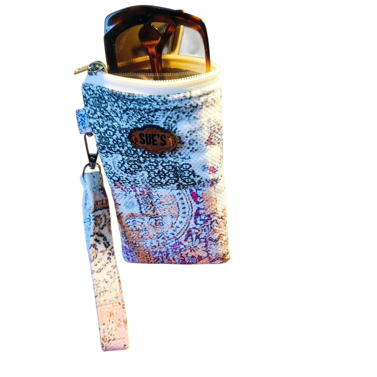 Suepatchwork handmade patchwork quilted glasses case with a wrist strap and zipper closure holding sunglasses