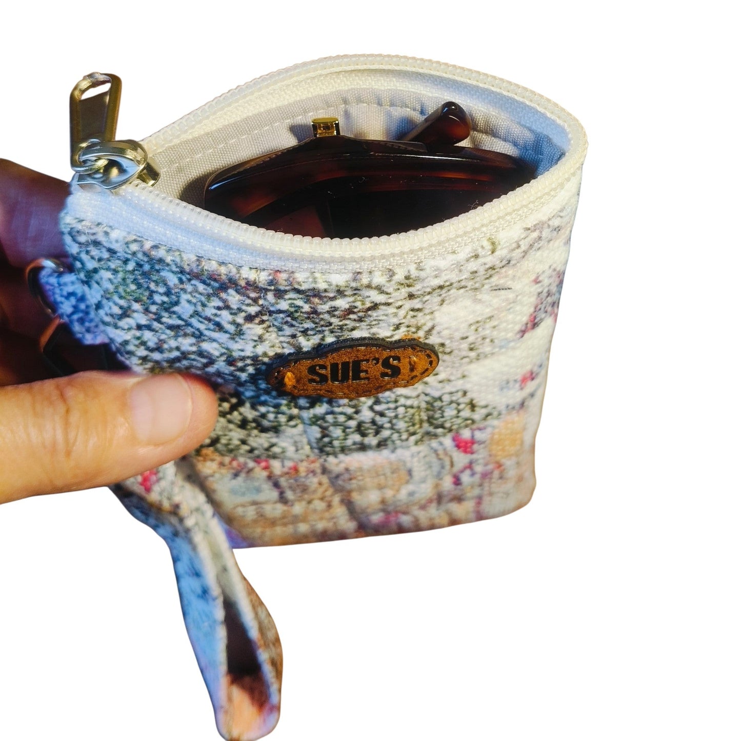 Suepatchwork handmade patchwork quilted glasses case with a zipper closure and a leather brand tag