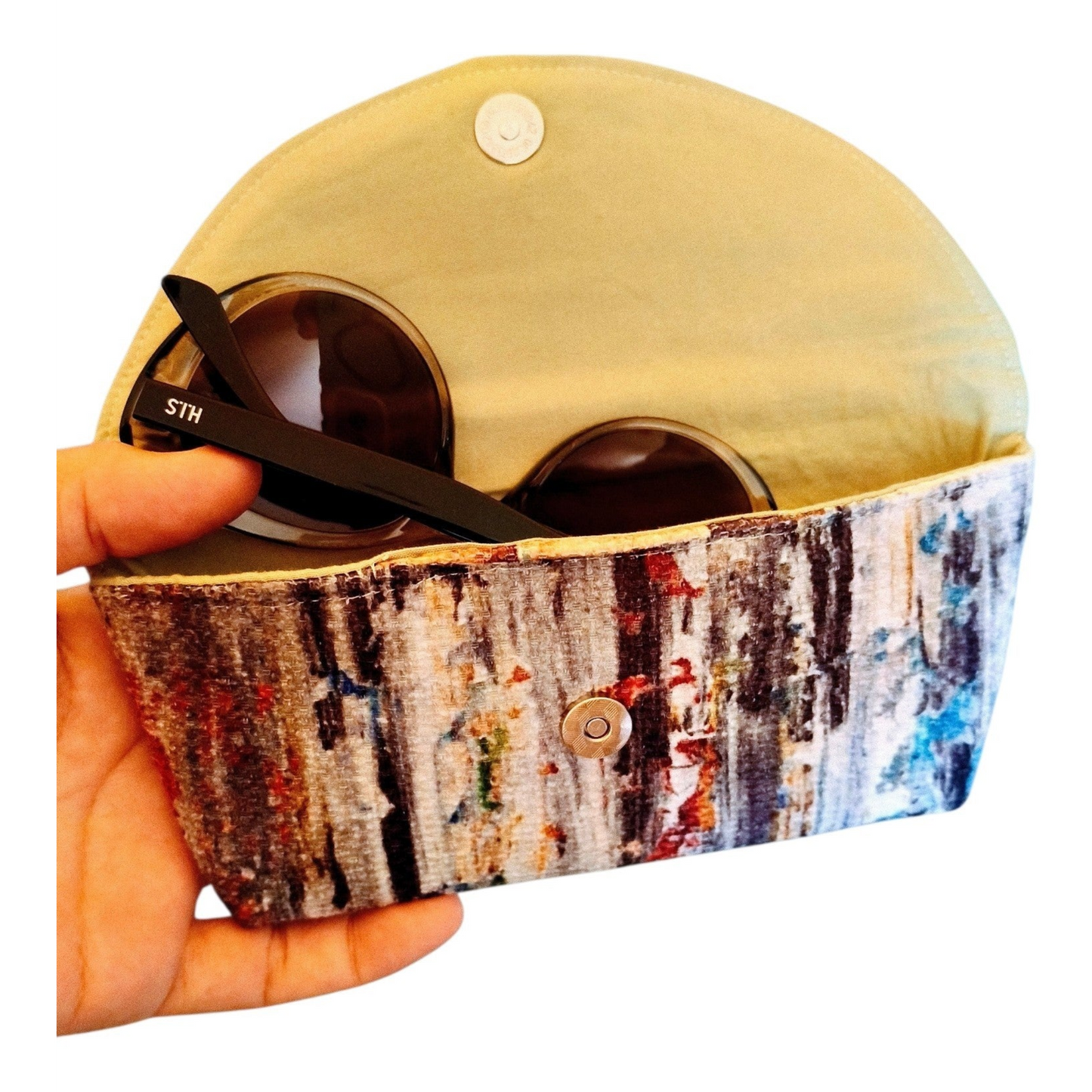 Suepatchwork handmade glasses case with a colorful scrambled pattern, featuring a magnetic snap closure.