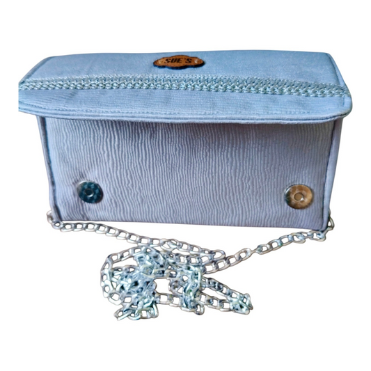 Suepatchwork silver evening wallet with a detachable chain strap, featuring a textured finish and branded logo tag.