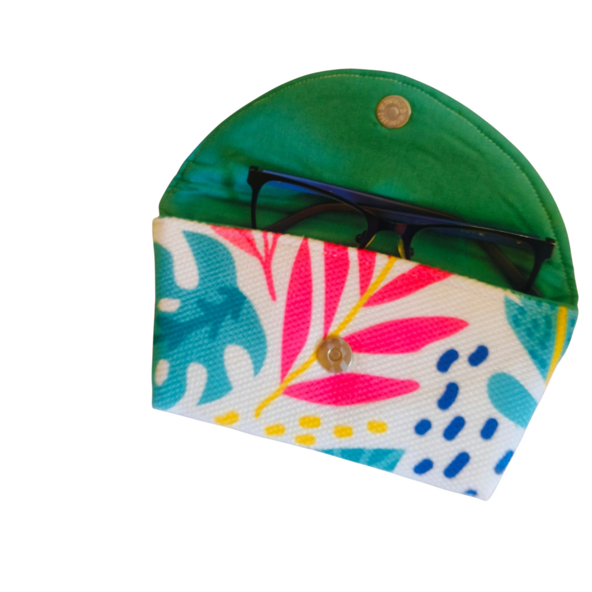 Suepatchwork handcrafted fabric glasses case with tropical leaf print, green lining, and secure magnetic closure.