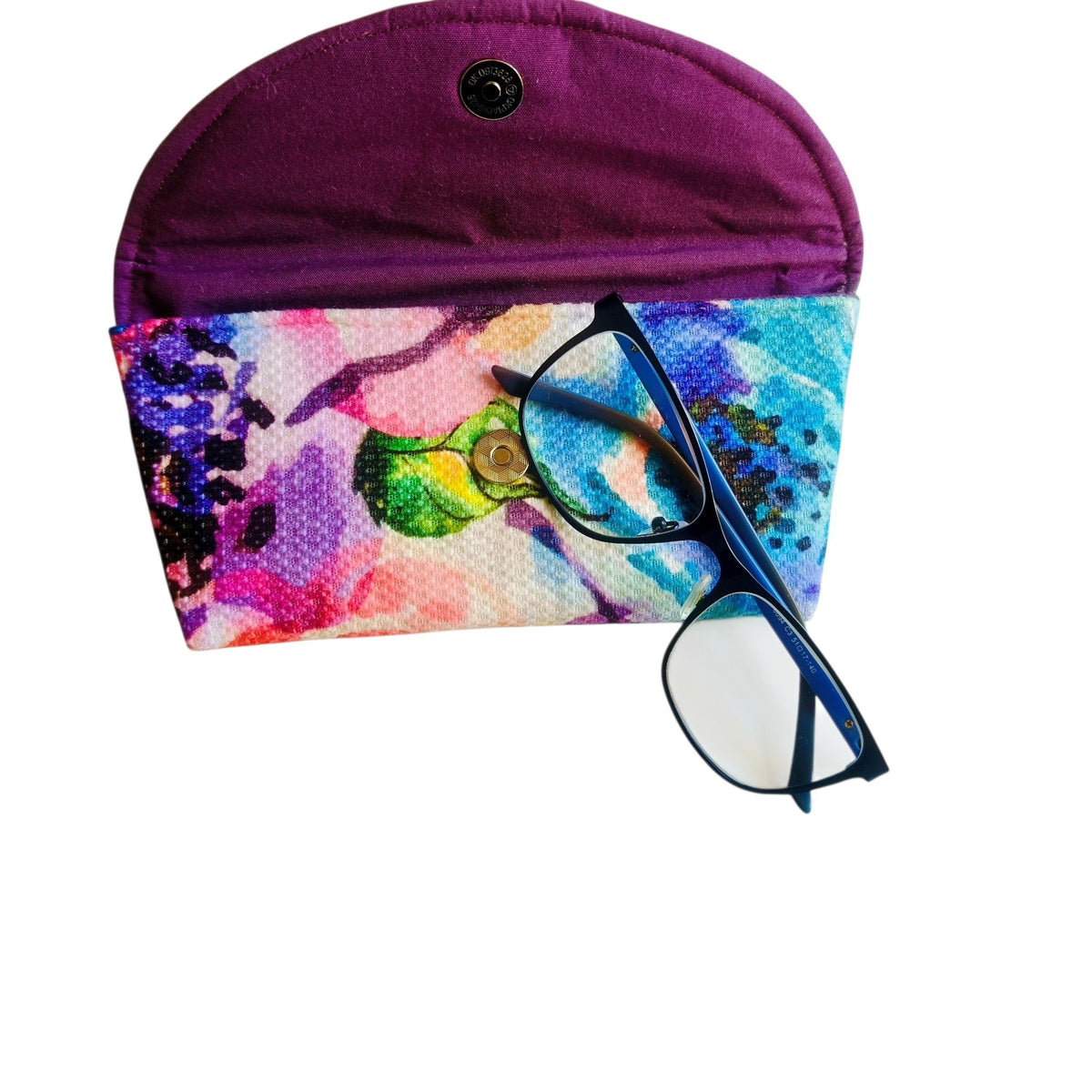 Suepatchwork handmade fabric glasses case with a vibrant watercolor floral print and a purple interior lining.