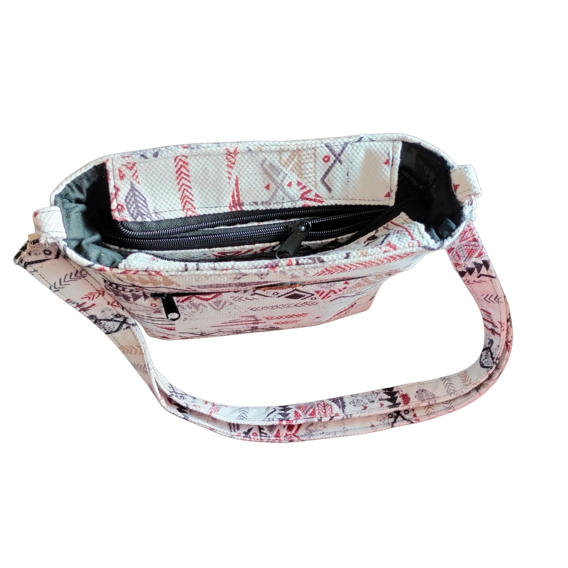 Suepatchwork white geometric patchwork crossbody bag with adjustable strap, zip closure, and soft cotton lining.