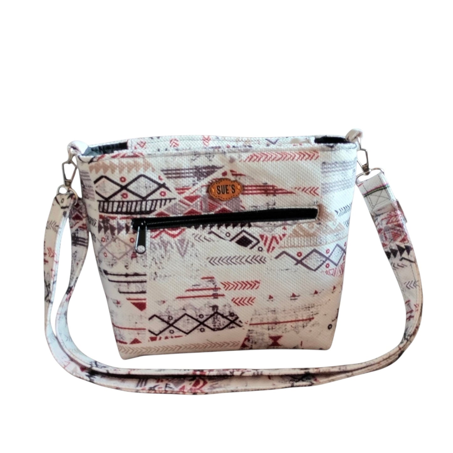 Suepatchwork white geometric patchwork crossbody bag with an adjustable strap and external zip pocket.