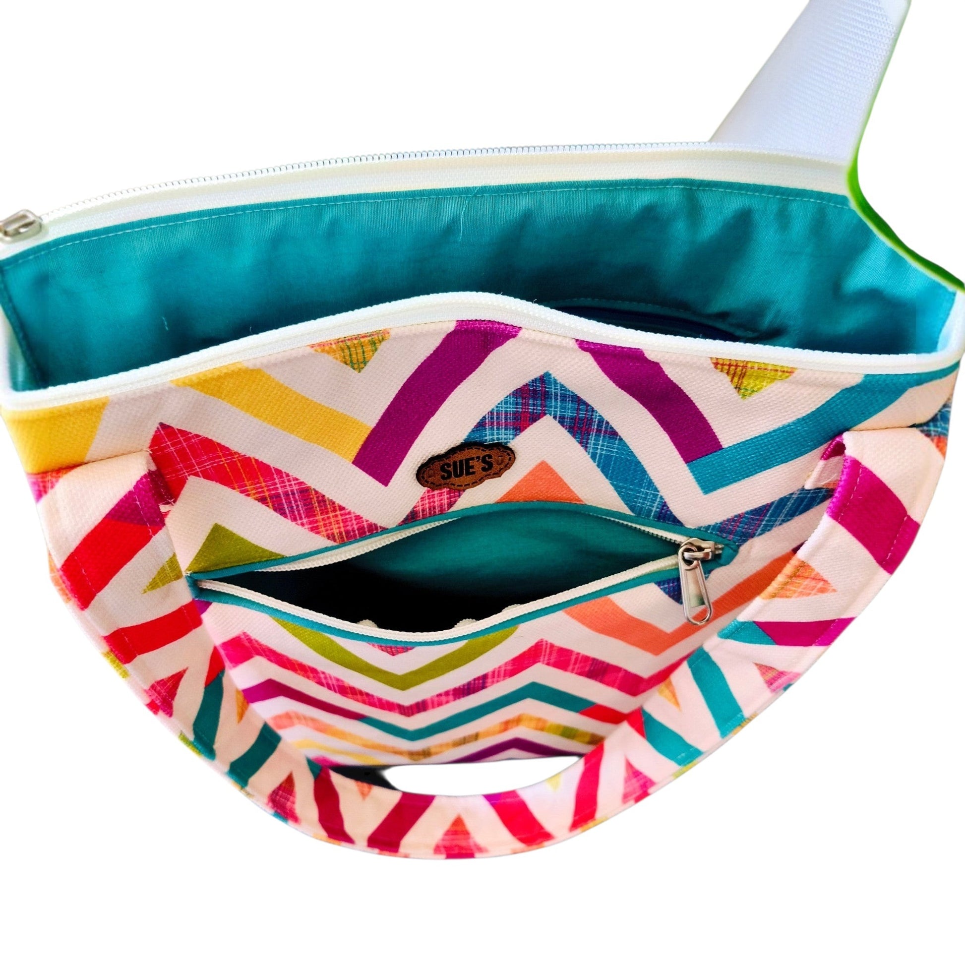 Suepatchwork zigzag patterned tote bag with teal lining, exterior zip pocket, and comfortable shoulder handles.